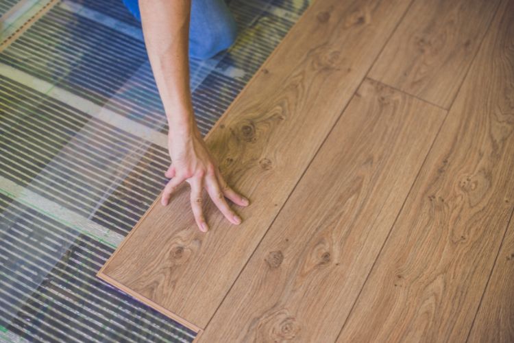 can you put electric floor heating under laminate